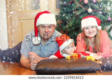 Young family on the eve of the New Year holidays at home
