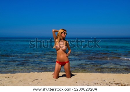 Beautiful blonde topless  on the beach