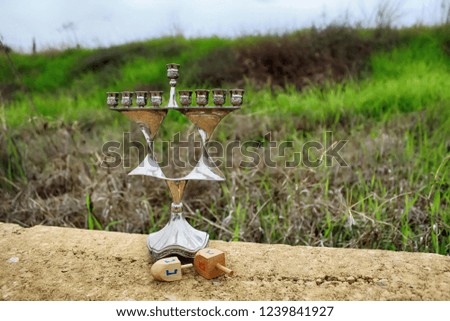 Hanukkah Menorah and Wood Dreidels (toy, holiday symbol). Jewish candlestick Menorah in style Jewish star Magen David, Israel. Image of Jewish holiday Hanukkah