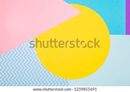Texture background of fashion blue, yellow and purple papers in memphis geometry style. Flat lay 
