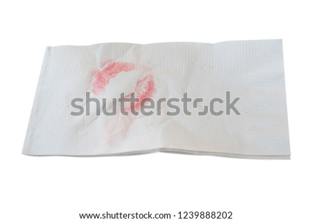 Napkin with red lipstick kiss isolated on white background.