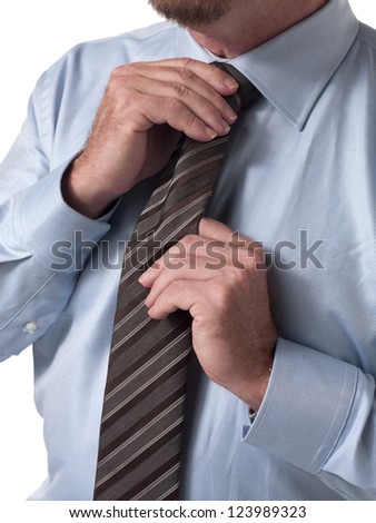 Mid section close-up of a mature businessman adjusting tie
