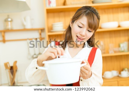 Beautiful asian woman in the kitchen