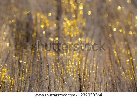 Blurred of Golden light with bokeh abstract for christmas and new year on old wooder background