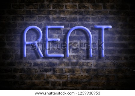 Rent. Neon inscription on the background of an old brick wall. Business. Real Estate. Rental of premises.
