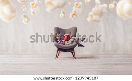 Sleeping little spectator with popcorn in the cinema