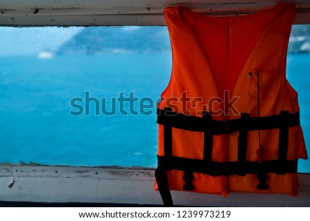 orange life jacket hanging in the boat, for safety.