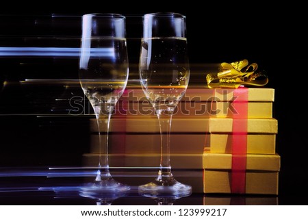Two wineglasses and gift boxes with movement effect