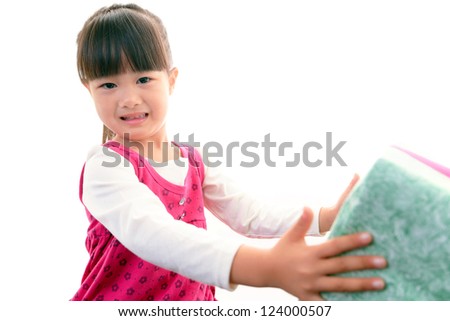 Joyful little girl holding present in hands
