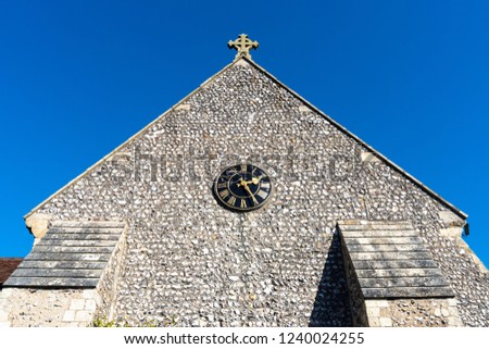 St Margaret's Church, graveyard and cross sign in the village of Rottingdean, East Sussex, England, United Kingdom.