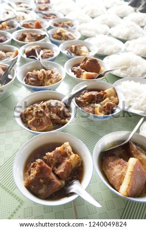 This dish is called Pork and Egg Stew or Caramelized Pork and Eggs (Thit Kho Trung). It is usually served with steamed rice and cooked vegetable or pickled vegetable. It is made of fresh coconut water