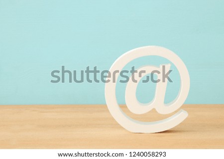 image of white mail icon over wooden desk