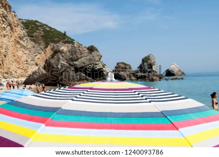 Multicolored beach umbrella close up with blurry background, Sesimbra Portugal