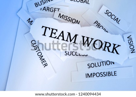 Torn newspaper headlines depicting business" Team work"