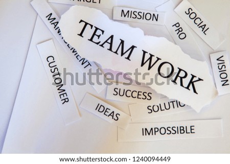 Torn newspaper headlines depicting business" Team work"