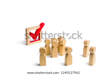 People stand near and look at the check mark in the box. election, poll or referendum. . Voters participate in elections of parliament or president. Decision making, teamwork. Poll Selective focus