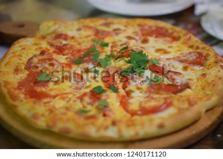 pizza on the table in a cafe, fast food, eating and people concept - close up