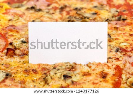 Blank card on baked pizza. Space for text.