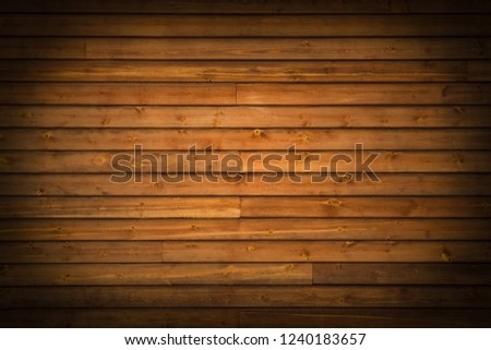 Horizontal wooden brown planks with vignetting as background (spotlight)