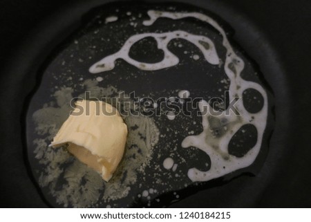       Melting butter in cast iron pan                         