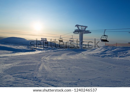 Ski lift in the rays of the sun