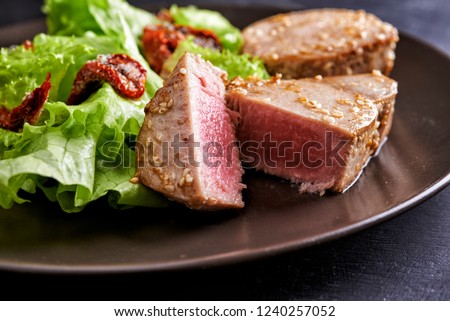 plate of tuna staek with salad Royalty-Free Stock Photo #1240257052