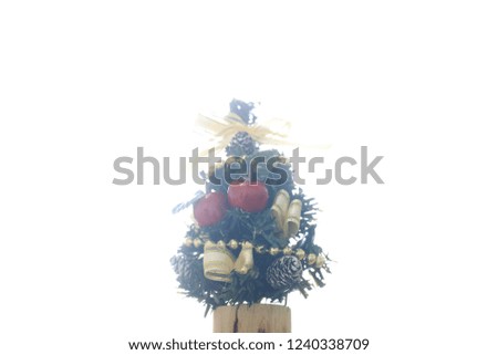 Close-up image of a small Christmas tree on white light with copy space for text