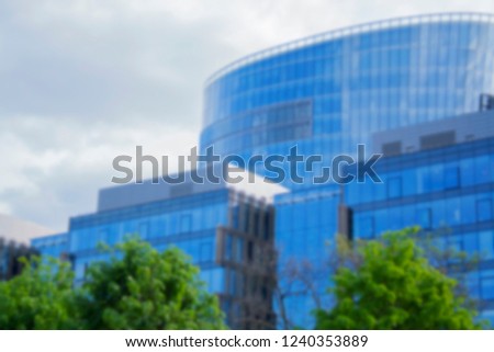 Building a corporate office business low angle. Glass and steel Art Nouveau business district skyscraper. Technological commercial photo. Blured.