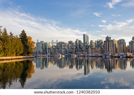 Skyline of Vancouver, British Columbia, with harbor and boats at sunset