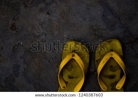 Yellow slippers in gray background