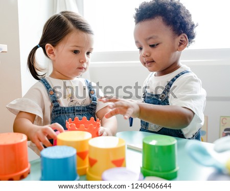 Little kids playing toys at learning center Royalty-Free Stock Photo #1240406644