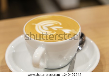 Latte coffee cup. A latte is a coffee drink made with espresso and steamed milk. The term as used in English is a shortened form of the Italian caffè latte, caffelatte or caffellatte.