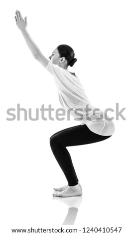 Young woman doing yoga exercise. Stretching on the floor. Isolated on white.