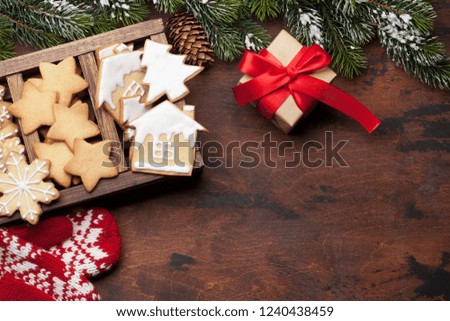 Christmas greeting card with gingerbread cookies and xmas gift box. Top view with space for your greetings