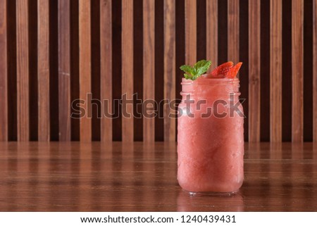 Fresh strawberries drink on wood