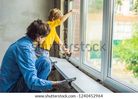 Father and son repair windows together. Repair the house yourself