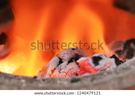 Close up coals in the fire. Background of flame heat. Select focus shallow depth of field.