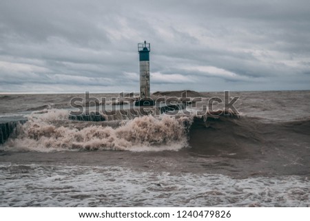 A storming blowing in off of Lake Erie Ontario Canada; Port Bruce Pier getting crashed in to by the rough waters and waves of the great lake;