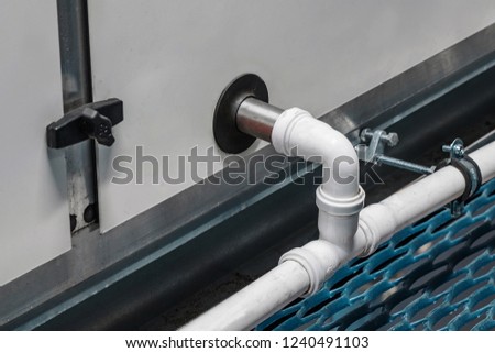 Close-up view of the drainage pipeline connected to the industrial air handling unit Royalty-Free Stock Photo #1240491103