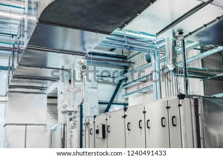 Side view of the huge industrial air handling unit in the ventilation plant room Royalty-Free Stock Photo #1240491433