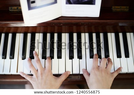 Young woman is practising piano at home. 