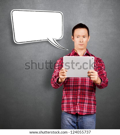 Asian man with speech bubble and touch pad in his hands embarrassed with news