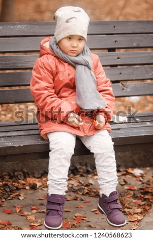 Pretty little girl in autumn park