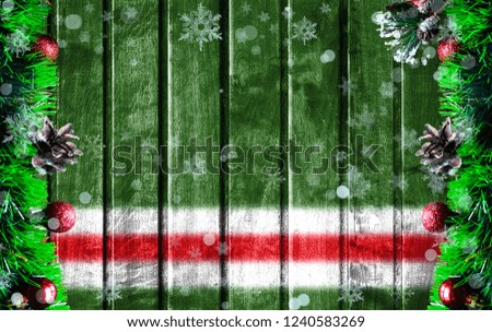 Wooden Christmas background with blurred flag of Chechen Republic of Ichkeria. There is a place for your text in the photo.