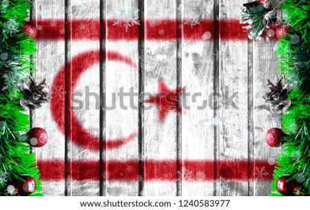 Wooden Christmas background with blurred flag of Turkish Republic of Northern Cyprus. There is a place for your text in the photo.