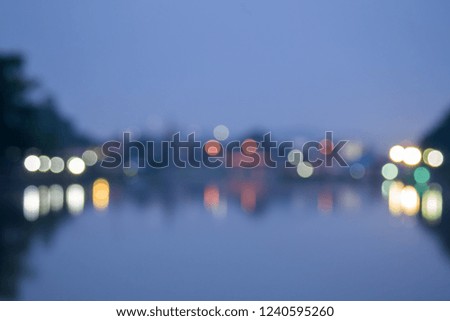 Abstract blurred / defocused of night river with reflect light bokeh on the water river