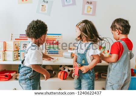 Young children playing with educational toys Royalty-Free Stock Photo #1240622437