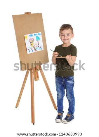 Child painting picture on easel against white background