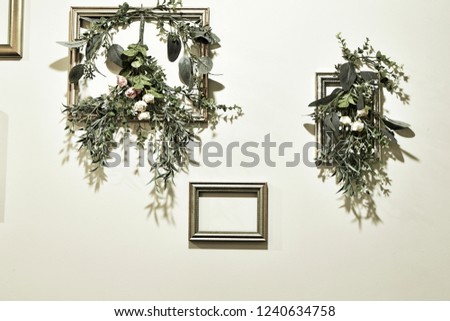 Flowers decoration and photo frame on wall 