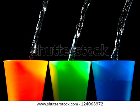 Three Children's multicolored plastic cups with splashes
